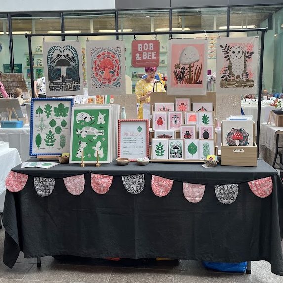 Market stall with vibrant risograph prints.